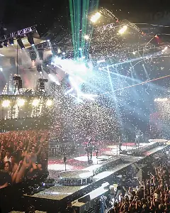 Concert stage with light show and crowd